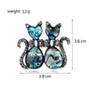 Pair of cats brooch with gemstones and measurements on a white background
