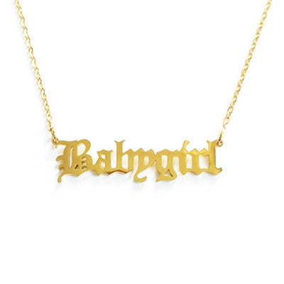 Gold 'Babygirl' necklace on a white background