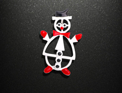 Cylindrical object with clown design on a black background, showing dimensions and weight.