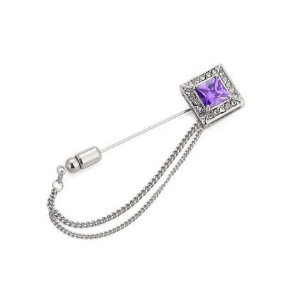 Brooch with purple gemstone and chain on a white background