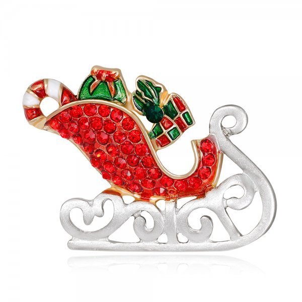 Christmas-themed brooch with red sleigh, candy cane, and gift box on a white background