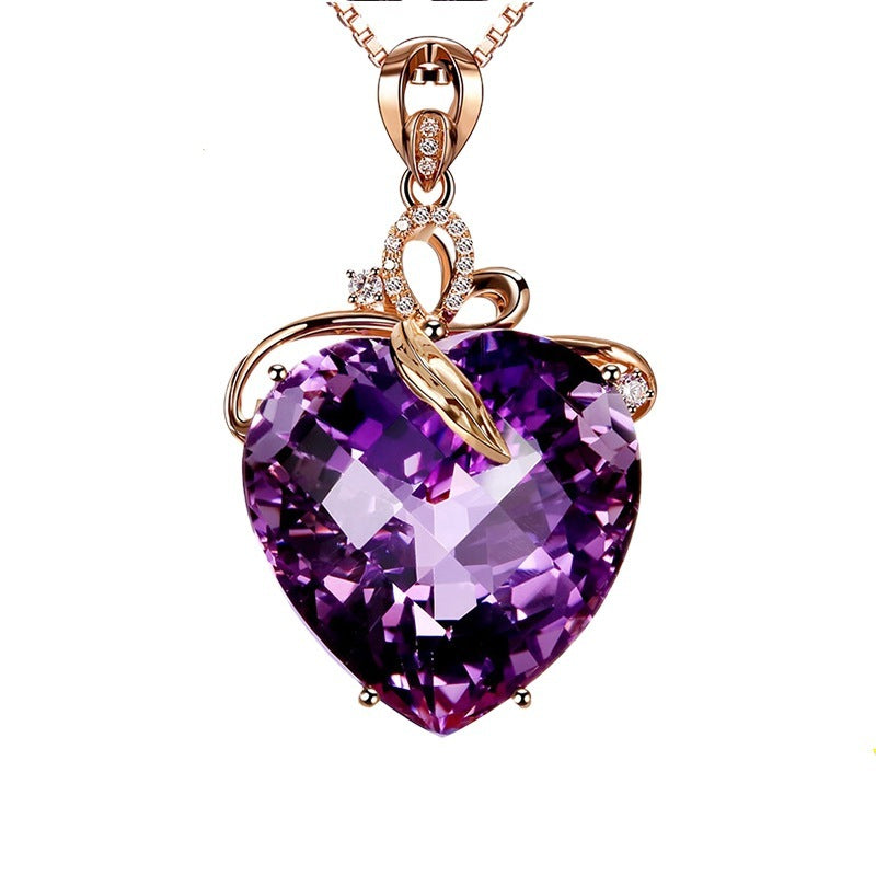 Heart-shaped purple gemstone necklace with rose gold chain on a white background