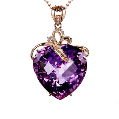 Heart-shaped purple gemstone necklace with rose gold chain on a white background