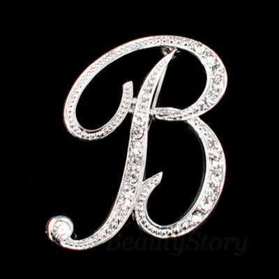 Silver letter 'B' brooch with rhinestones on a black background