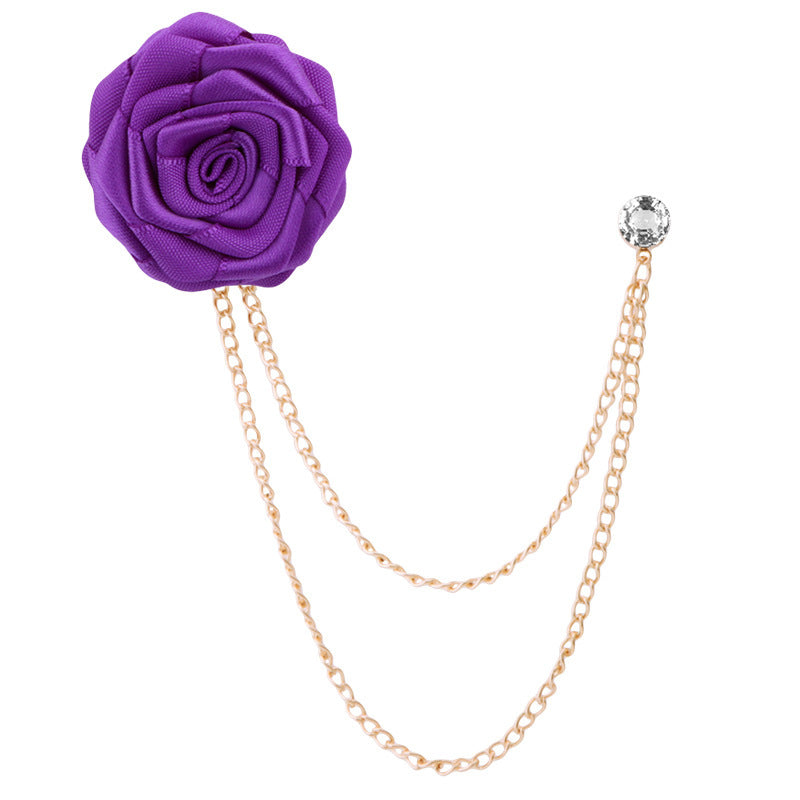 Purple flower brooch with gold chain on a white background