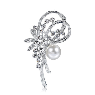 Silver brooch with floral design and pearl on a white background