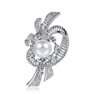 Elegant brooch with pearl and crystals on a white background