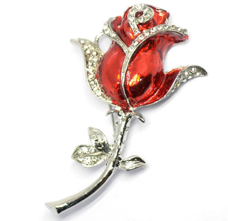 Red rose brooch with silver accents on a white background