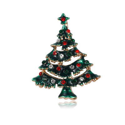 Christmas tree-shaped brooch with red and clear gemstones on a white background