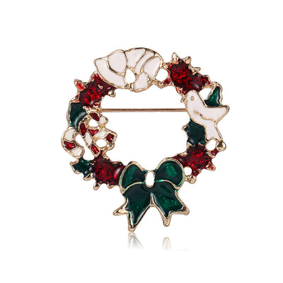 Decorative brooch with a wreath design featuring red, green, and white colors on a white background.