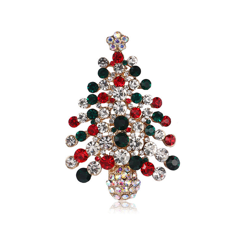 Christmas tree-shaped brooch with red, green, and clear gemstones on a white background