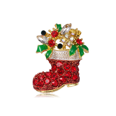 Decorative brooch shaped like a red Christmas boot with gemstones on a white background