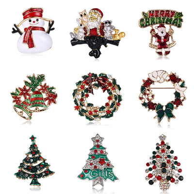 Collection of Christmas-themed brooches including Santa Claus, wreaths, and trees on a white background.