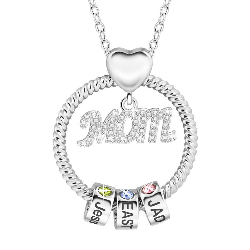 Silver necklace with heart pendant and name charms on a white background