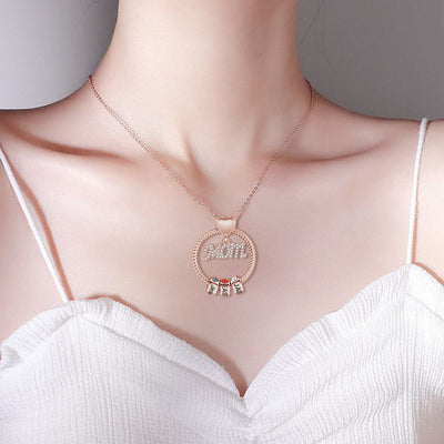Necklace with 'Mom' pendant on a model wearing a white top