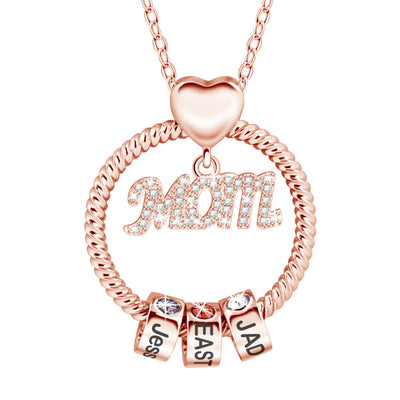 Rose gold necklace with 'Mom' pendant and name charms on a white background