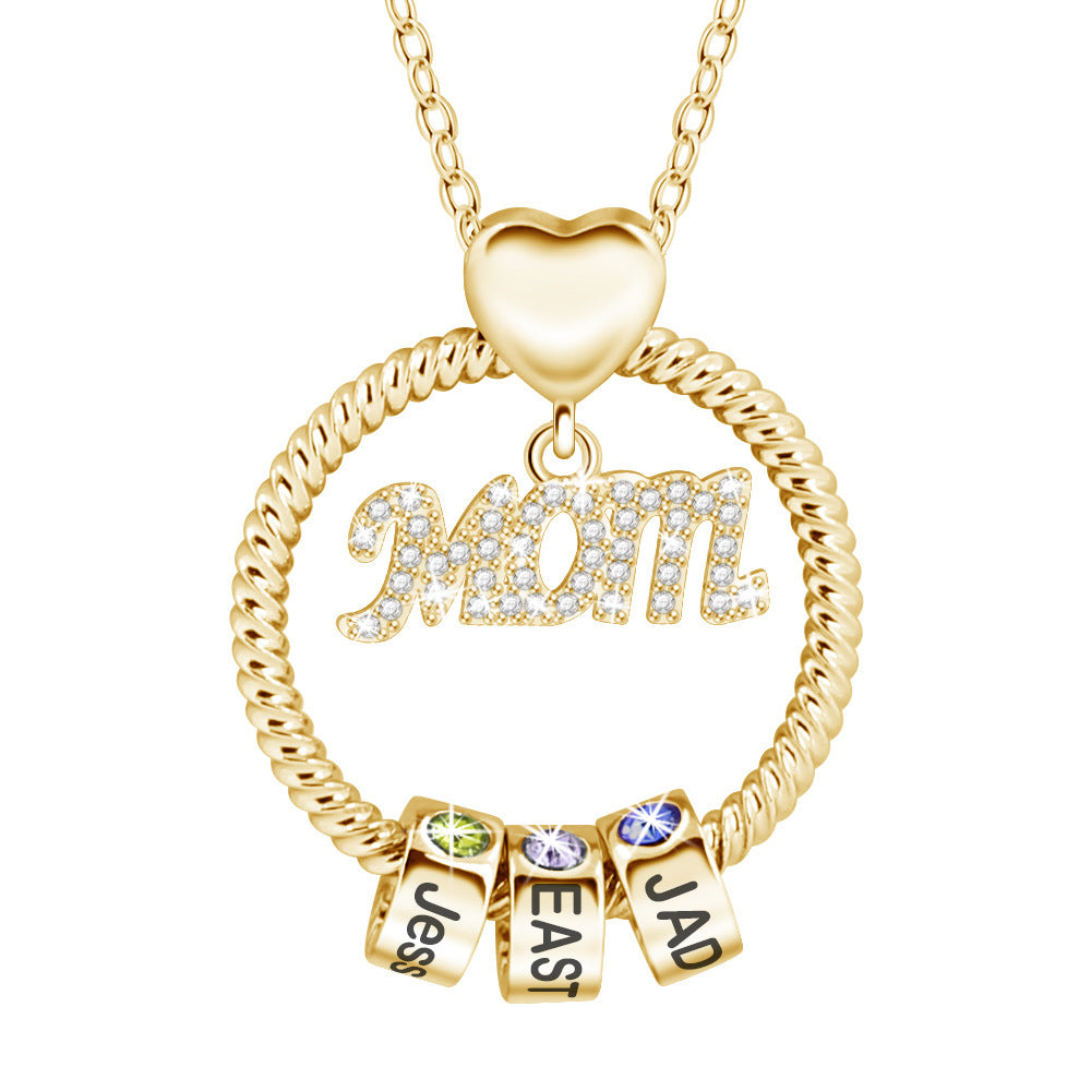 Gold necklace with 'Mom' pendant and name charms on a white background