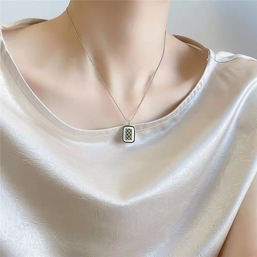 Necklace with a pendant on a mannequin wearing a white top
