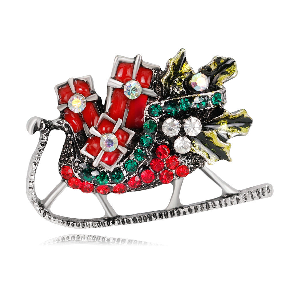 Decorative brooch with red, green, and silver colors on a white background