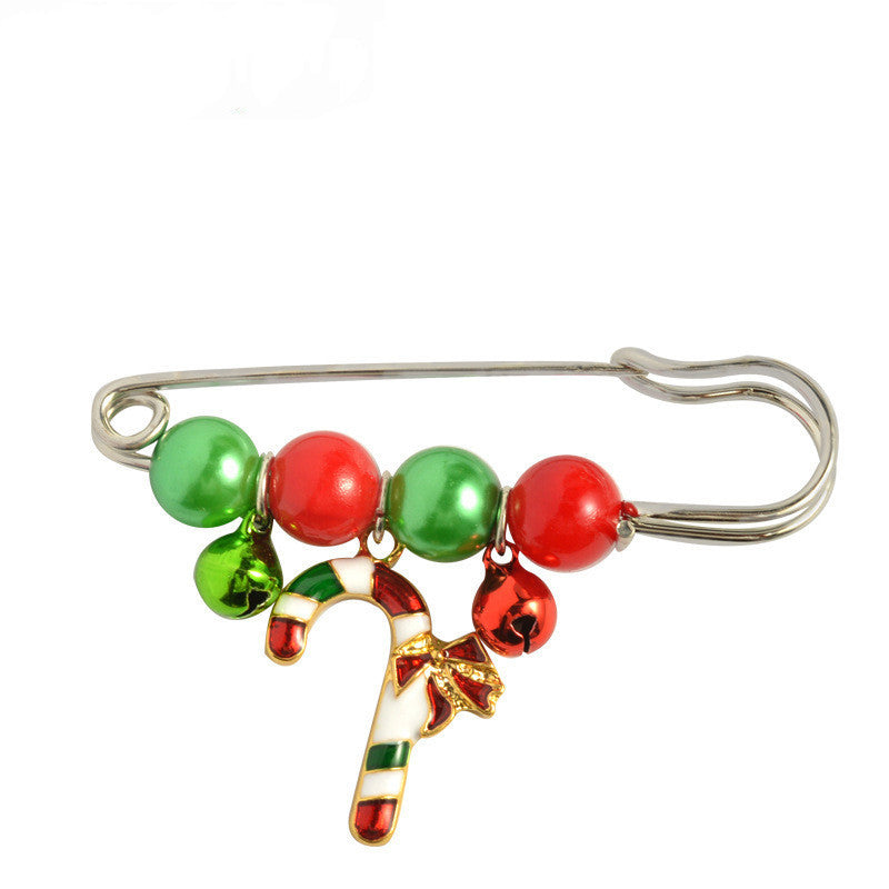 Christmas-themed brooch with red and green beads on a white background