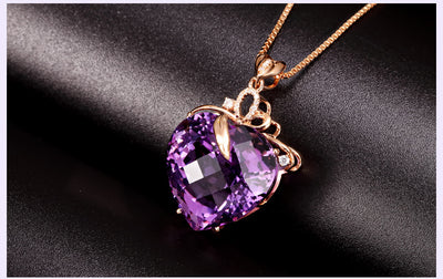 Purple heart-shaped gemstone necklace on a dark background