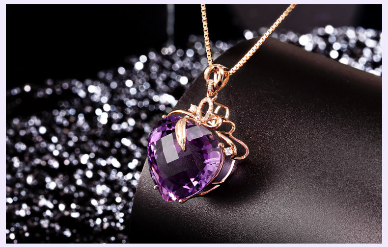 Purple heart-shaped gemstone necklace on a dark background