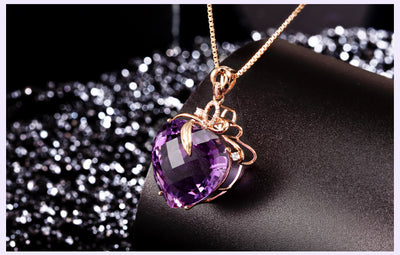 Purple heart-shaped gemstone necklace on a dark background