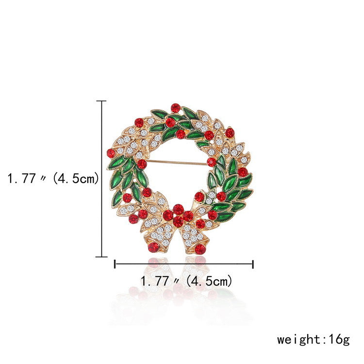Decorative brooch with green leaves and red berries, measurements, and weight displayed.