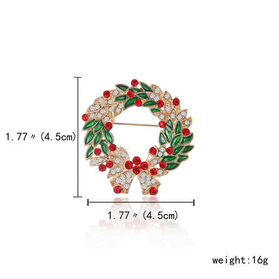 Decorative brooch with green leaves and red berries, measurements, and weight displayed.