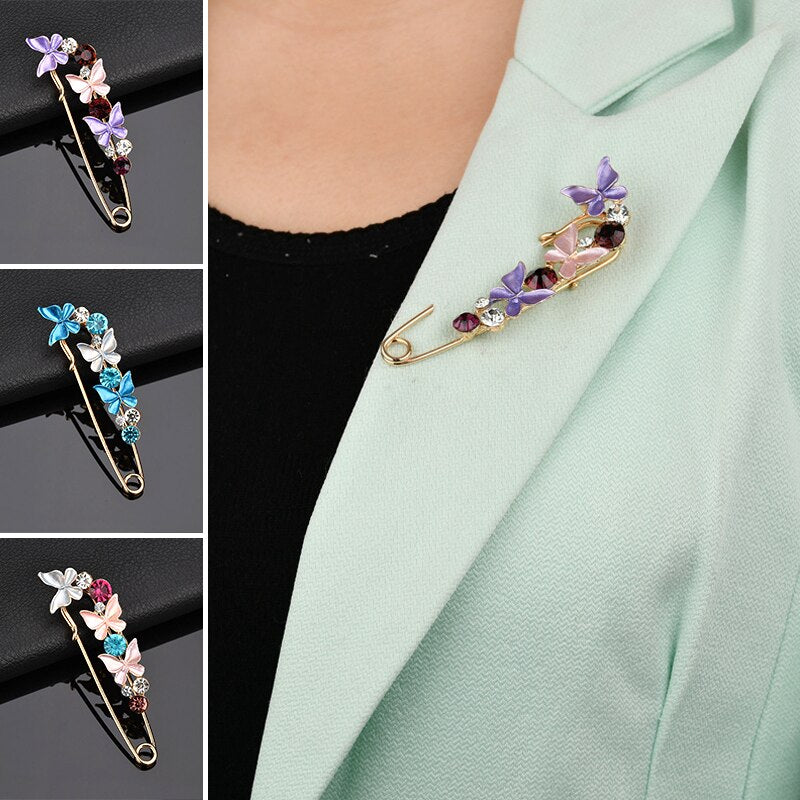 Colorful butterfly-shaped brooches on a light green blazer with close-up views.