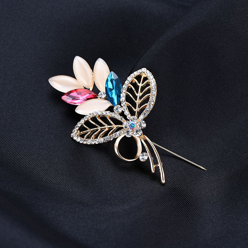 Decorative brooch with gemstones on a dark fabric background