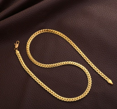 Gold chain on a brown leather surface