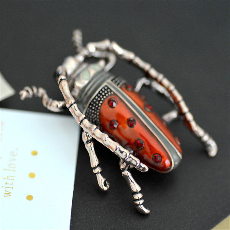 Decorative beetle with red and silver design on a black background