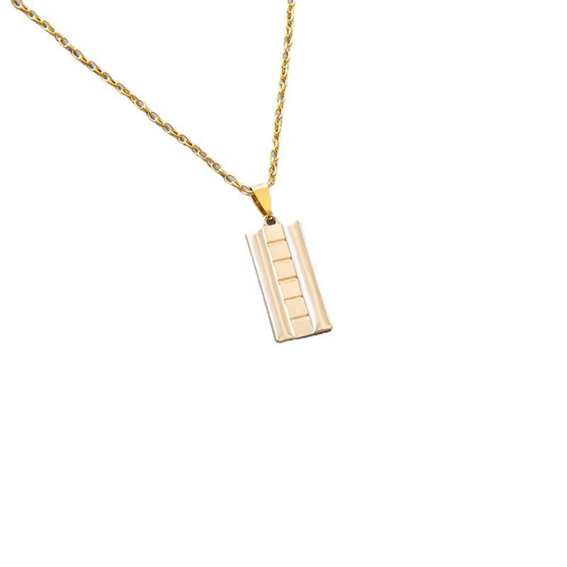 Gold necklace with a rectangular pendant on a white background