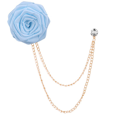 Light blue flower brooch with gold chain on a white background