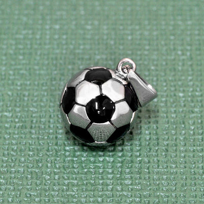 Soccer ball charm on a textured green background