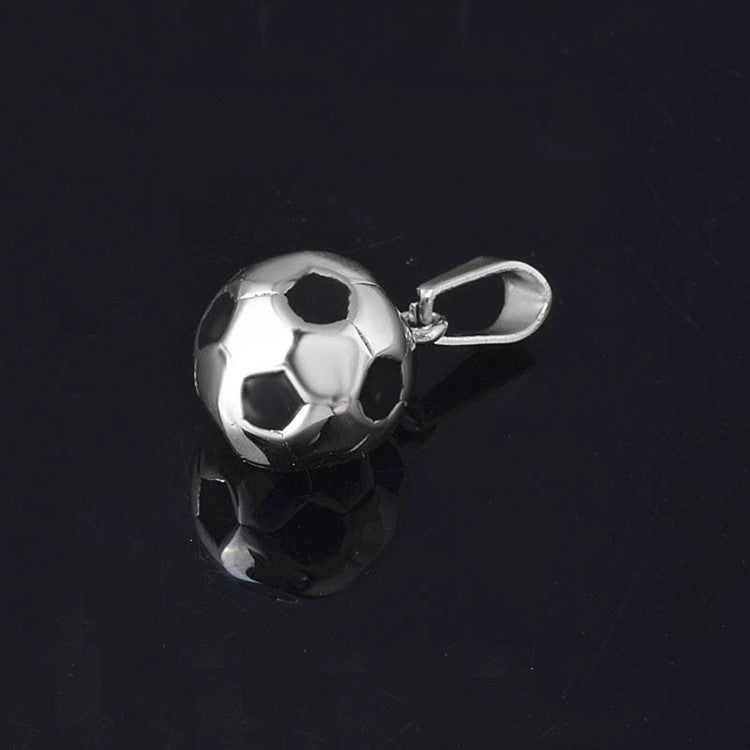 Silver soccer ball charm on a black background