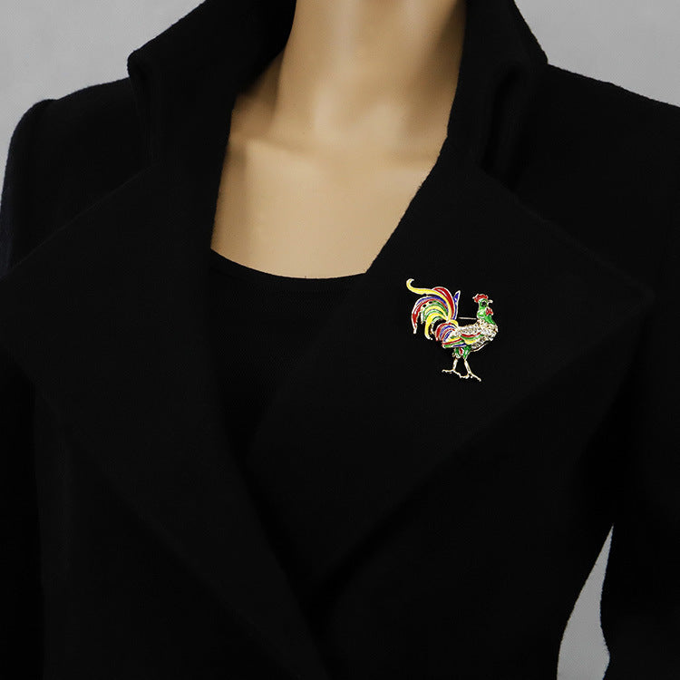 Black blazer with a colorful rooster brooch on a neutral background