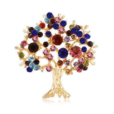 Colorful tree-shaped brooch with gemstones on a white background