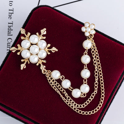 Pearl and gold earring on a red velvet surface