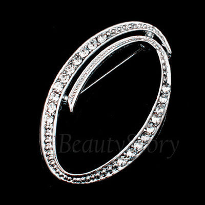 Silver ring with clear stones of letter O on a black background, branded 'Beauty Story'.
