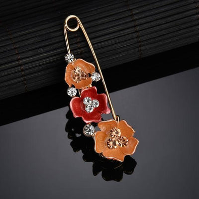 Decorative brooch with floral design on a dark surface