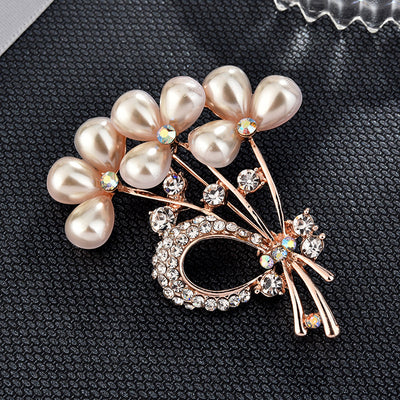 Pearl and crystal brooch on a textured black surface