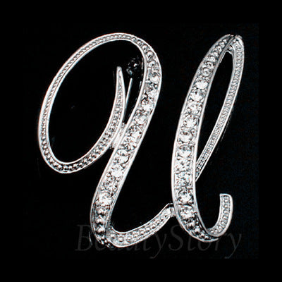 Silver letter 'U' brooch with clear crystals on a black background
