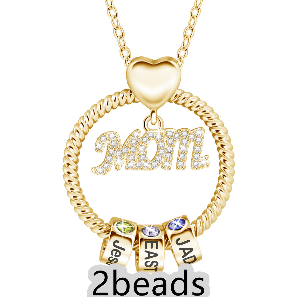 Gold necklace with 'Mom' pendant and three name beads on a white background 2 beads
