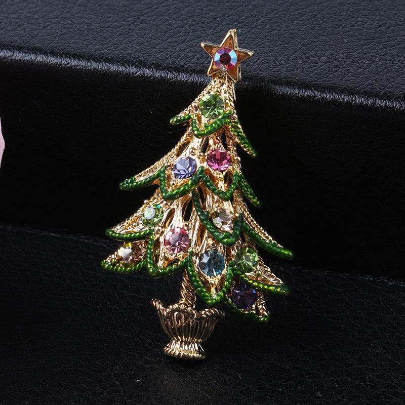 Decorative Christmas tree brooch with gemstones on a black background