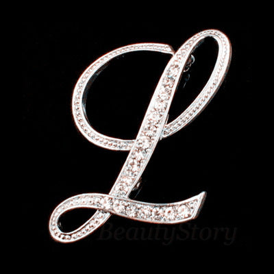 Silver brooch with letter 'L' design on a black background