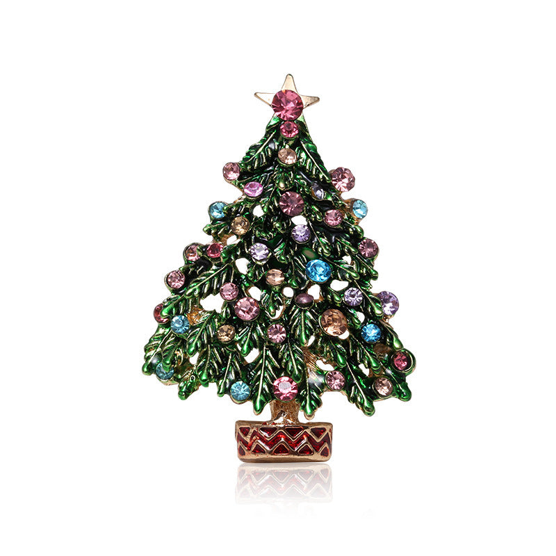Decorative Christmas tree brooch with colorful gemstones on a white background