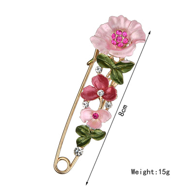 Floral brooch with pink flowers and green leaves, size 8cm, weight 15g, on a white background