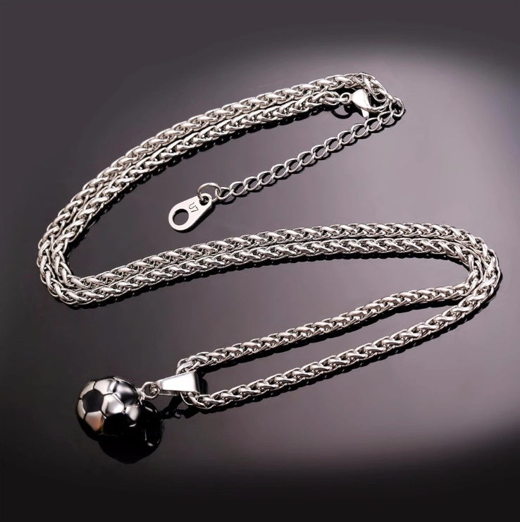 Silver chain necklace with a spherical pendant on a dark background
